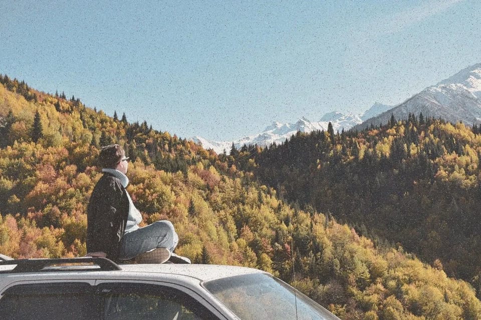 A car parked at a mountain lookout